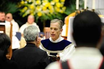                                                              Catholic Sentinel photo by Bob KernsArchbishop Sample gives Communion during installation Mass. 